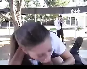 Girl makes a blowjob in the park while people go