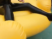 Carrie LaChance in black latex catsuit for a photoshoot