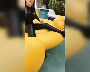 Carrie LaChance in black latex catsuit for a photoshoot