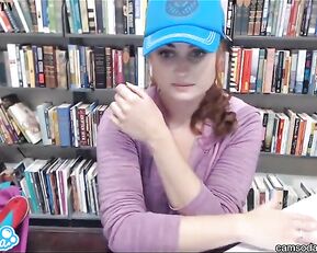 Lovely redhead gets dirty in library
