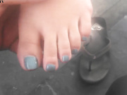 Asian cutie shows her feet at the gasstation