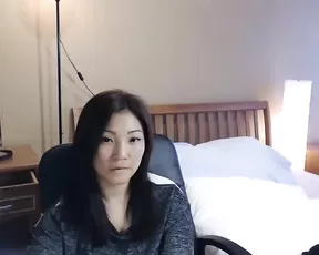 Tattooed Asian stretching her shaved puss