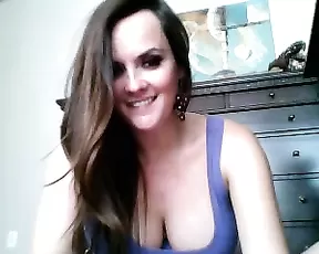 A red haired hottie suckles on a plastic cock