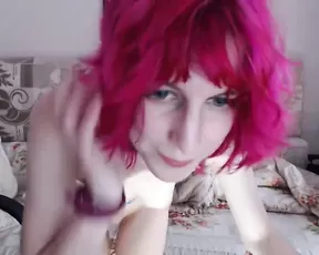 A cute looking red haired teen gets naked on cam