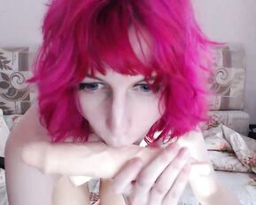 A cute looking red haired teen gets naked on cam