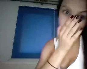 A busty blonde is getting naked while teasing