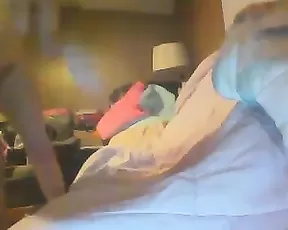A tanned brunette is masturbating