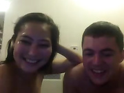 A tattooed brunette plays around with her tits