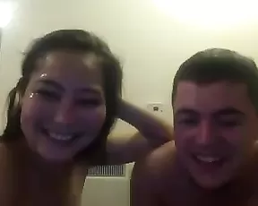 A tattooed brunette plays around with her tits