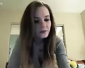 Redhead licks her tits before the camera