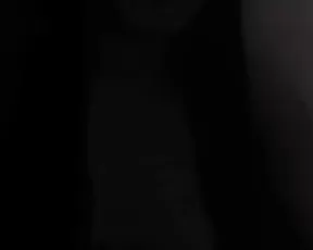 A dark haired hottie teases before stripping