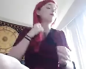 A small breasted red head is getting off on camera