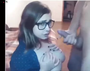 A cute brunette is getting recorded while sucking cock