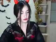 A petite brunette looking into the cam and sucking hard